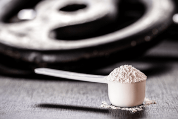 creatine powder in front of weights